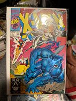 Front cover of the X-Men #1 comic book with clear Marvel Comics logo, issue number, price, and art characters including Nightcrawler, Storm, Cyclops, and Professor X.
