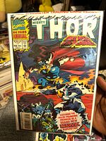 Photo of The Mighty Thor #18 1993 comic showing front cover with Thor and female Loki characters, bagged and boarded