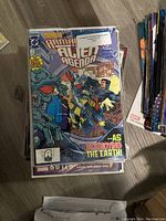 Stack of various comic books including Monarch Batman Alien Agenda
