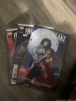 Six Anita Blake: Vampire Hunter comics laid on a wood floor, showing front covers including 'Circus of the Damned'.