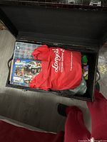 Black trunk interior showing red Longo’s grocery bag, clear organizer box and City set manual