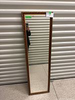 Full view of the rectangular mirror showing the entire frame and reflective surface.