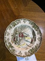 Single Johnson Brothers Friendly Village bread and butter plate showing winter village scene and leaf border.