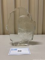 Front view of clear glass owl sculpture with textured owl inside, displayed against vertical blinds background.