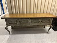 Full front view of the mid-century modern sideboard table showing the carved panel doors, cabriole legs, and wood finish.
