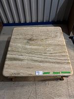 Top-down view of the square marble coffee table top showing natural veining and smooth surface.