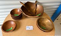 Photo showing the collection of wooden bowls including the large salad bowl, small bowls stacked and medium bowls.