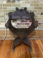 Front view of the carved wooden chair showing overall design and dimensions