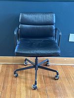 Front view of chair showing seat cushion, back cushion, base and casters