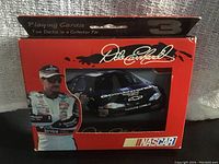 Photo of red and black collector tin featuring Dale Earnhardt with racing image and signatures