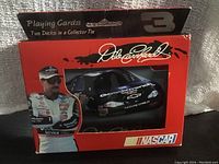 Photo showing red collector tin with Dale Earnhardt image, car and NASCAR branding; displays tin design and graphics