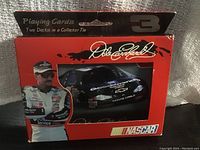 Collector tin showing Dale Earnhardt and his NASCAR race car with official branding.