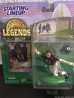 Photo of the Starting Lineup Legends Dick Butkus collectible figure in original sealed packaging showing the figure in football uniform with helmet and Hall of Fame Legends background.