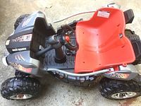 Top view of kids ride-on dune racer car showing red seat and steering wheel