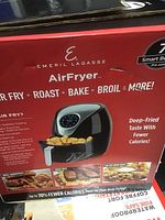 Box of Emeril Lagasse Air Fryer showing branding, cooking functions, and product images.