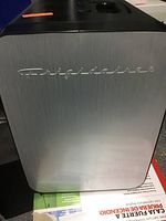 Front view of Frigidaire mini refrigerator showing stainless steel door panel with logo