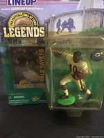 Full view of Gale Sayers action figure in white uniform in sealed packaging with Hall of Fame Legends branding.