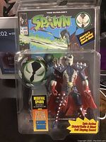 Front view of the new in box Medieval Spawn action figure by Todd McFarlane alongside the special edition comic book.
