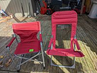 Two red foldable lawn chairs on wooden deck, one with padded backrest and mesh window, one with fabric backrest and arm rests, metal frames