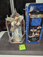 Heavenly Angel figurine standing approximately 19 inches tall next to its original box, detailed with white and gold gown and wings.