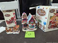 Two-piece Lemax Sugar 'N Spice set with original box, including the porcelain lighted house and reindeer sleigh figurine.