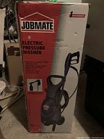 Photo of Jobmate Electric Pressure Washer box showing product image and key features such as 1500 PSI, 1.5 GPM, adjustable spray nozzle, universal motor, and 23 ft power cord.