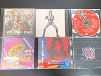 Front covers of 6 different music CDs including Buddha Bass Volume One, Billy Squier album, Red Disc Dance Mix, Dance Volume 22, Max Million, and a colorful compilation album.