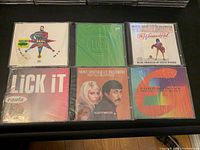 Front view of six sealed vintage music CDs packed side by side showing album covers and titles.