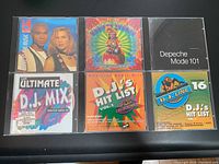 Front view of six vintage music CDs showing cover art for Slave to the Music, Freddie Fresh, Depeche Mode 101, and three DJ hit list compilations.