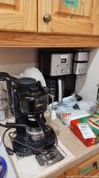 Wide view of countertop with Salton cappuccino maker, electric kettles, and coffee accessories