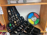 Darth Vader helmet-shaped storage case filled with Star Wars figures and Simon game beside case