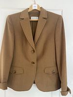 Front view of camel Basler cashmere jacket on a hanger showing tailored fit, button closure, and flap pockets.