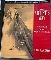 Cover of The Artist's Way book showing a mountain design and title as a spiritual path to creativity
