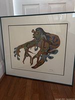 Full view of framed Indigenous art lithograph showing colorful abstract figures.