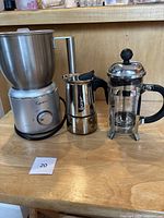 Full set showing Capresso frother, Bialetti espresso maker, and Bodum coffee maker on wooden surface