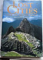 Front cover of the hardcover coffee table book titled 'Lost Cities from the Ancient World' featuring an image of Machu Picchu.