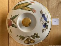Top view of Evesham lidded casserole showing lid with fruit and vegetable decoration and gold knob.
