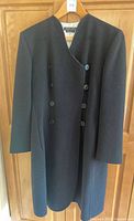 Full front view of black cashmere coat dress on hanger