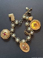 Full view of bracelet with charms on black background