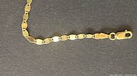 Section of chain showing lobster clasp and 14KT stamp