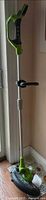 Greenworks cordless string trimmer and edger standing vertically showing handle and shaft