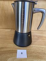 Front view of Grosche stovetop espresso maker showing brand name and product shape.