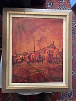 Framed oil on canvas painting depicting a Middle Eastern cityscape in red-orange tones viewed from above.