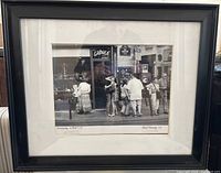 Framed photograph showing the entire piece including the matting, black frame, and glass covering.