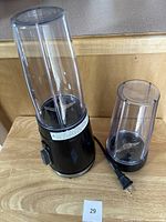 Full view of Heritage personal blender base with two blending cylinders attached, one tall and one shorter, both clear plastic.