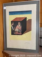 Full view of framed lithograph against wooden door