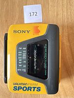 Top front of the yellow Sony Walkman showing FM/AM frequency display and Auto Reverse cassette window.