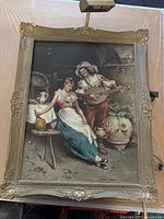 Full view of the framed painting showing a man playing lute and woman sitting on a bench in a rustic setting with pottery and wood furniture.