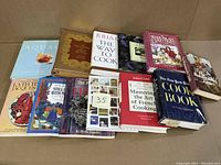 Photo of the 12 cookbooks arranged side by side showing cover details and titles