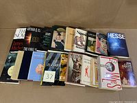 Photo showing all 19 books arranged on a flat surface, displayed front and back covers visible.